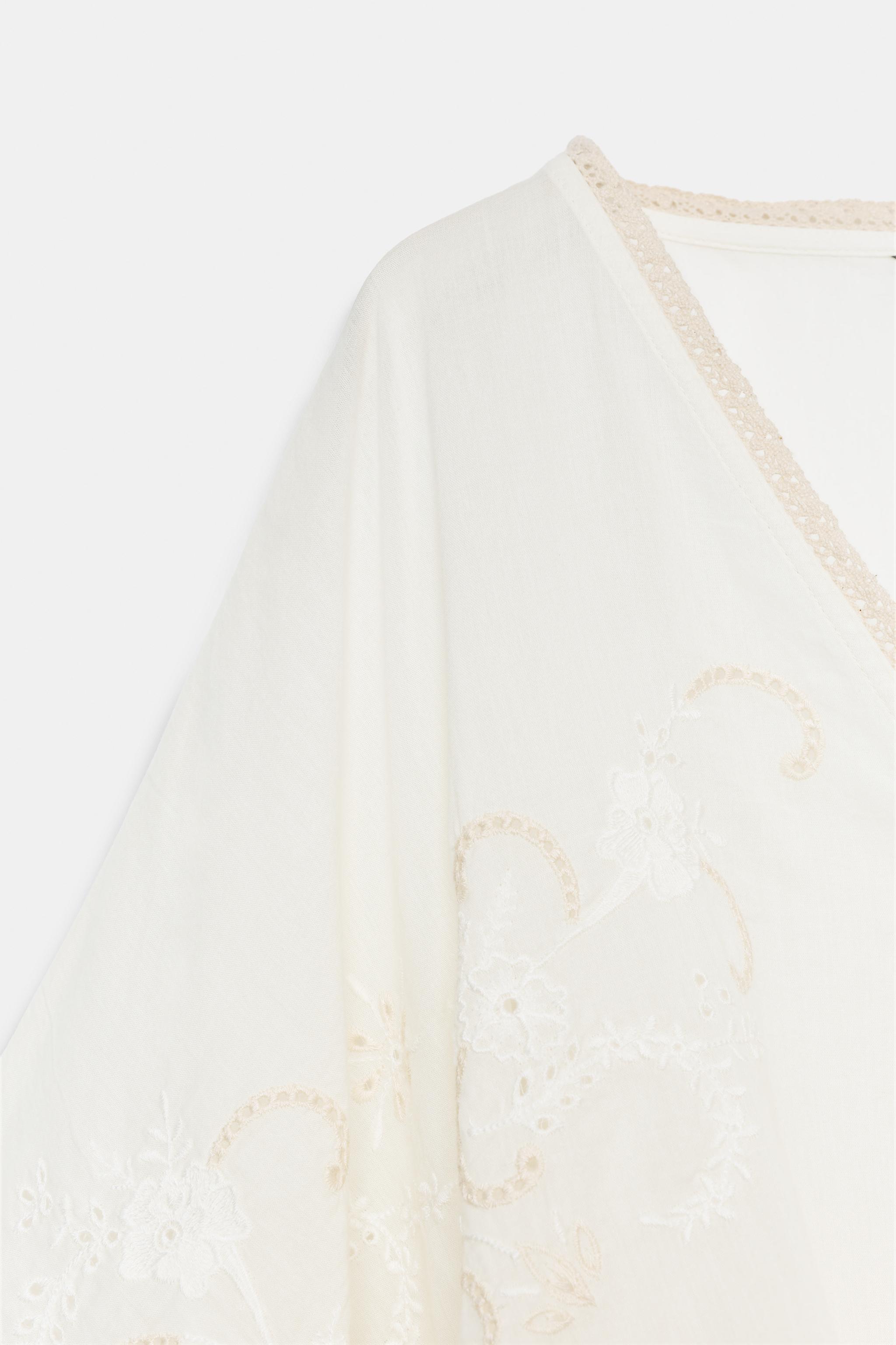 EMBROIDERED CAPE TOP
